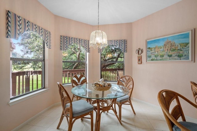 dining space with light tile patterned floors, a notable chandelier, and a healthy amount of sunlight