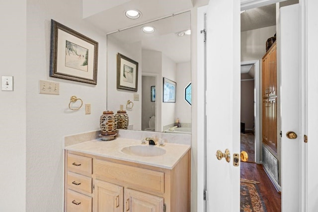 bathroom with hardwood / wood-style flooring and vanity