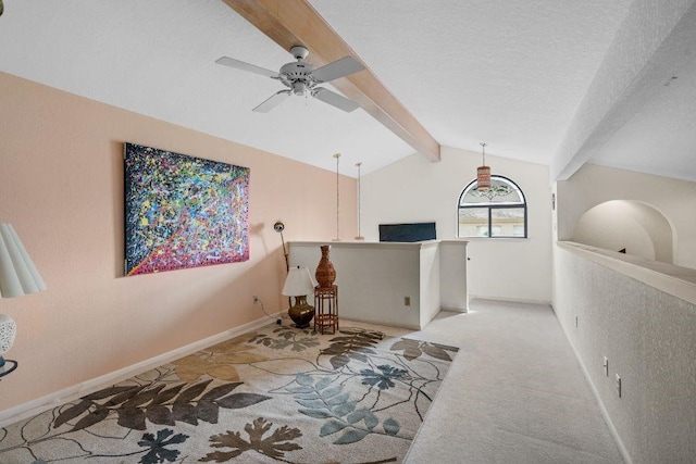 interior space with a textured ceiling, light carpet, and vaulted ceiling with beams