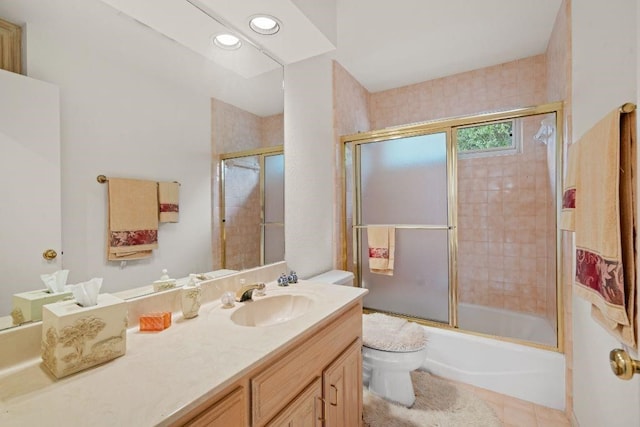 full bathroom featuring toilet, shower / bath combination with glass door, tile patterned floors, and vanity