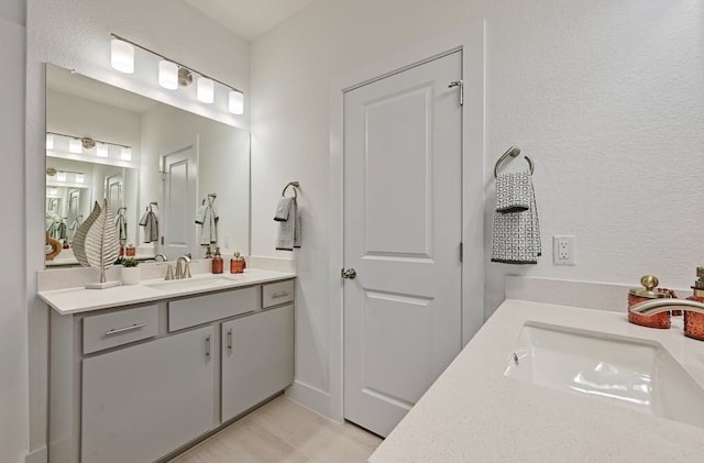 bathroom featuring tile patterned flooring and vanity