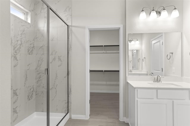 bathroom featuring vanity and a shower with shower door