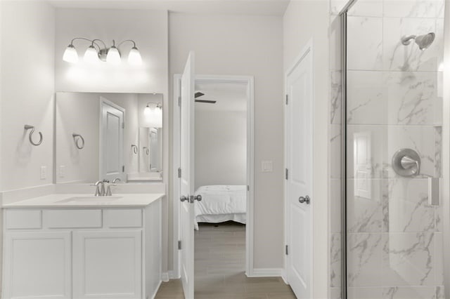 bathroom featuring vanity, wood-type flooring, and a tile shower