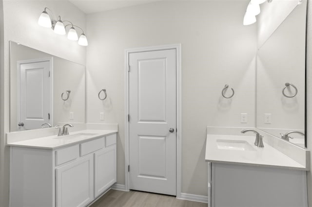 308 Yellowstone Dr, Kyle, TX 78640 - full bathroom featuring wood finished floors, a sink, and two vanities