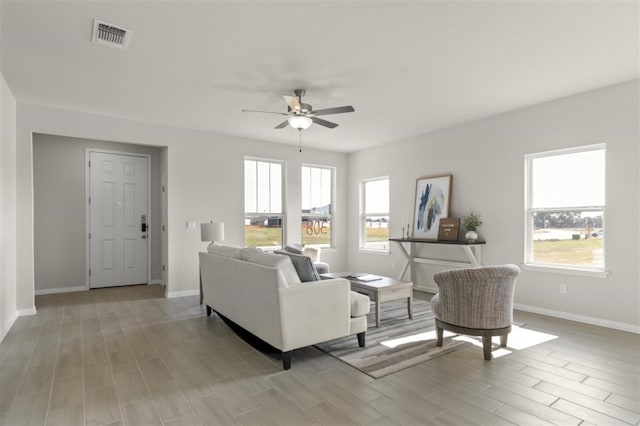 308 Yellowstone Dr, Kyle, TX 78640 - living area with light wood-style floors, a ceiling fan, baseboards, and visible vents