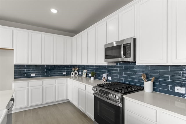 308 Yellowstone Dr, Kyle, TX 78640 - kitchen with light countertops, white cabinetry, appliances with stainless steel finishes, and tasteful backsplash