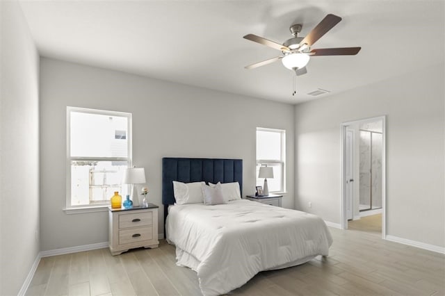 308 Yellowstone Dr, Kyle, TX 78640 - bedroom featuring ensuite bath, light wood-style floors, a ceiling fan, baseboards, and visible vents