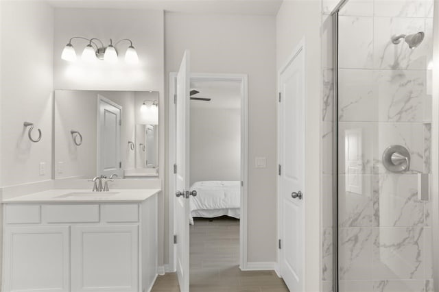 308 Yellowstone Dr, Kyle, TX 78640 - bathroom featuring ensuite bath, vanity, baseboards, a shower stall, and wood finished floors