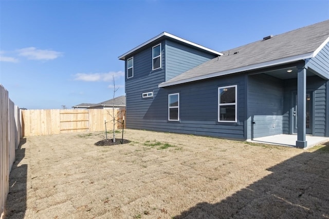 308 Yellowstone Dr, Kyle, TX 78640 - rear view of house featuring a patio, a fenced backyard, and a shingled roof