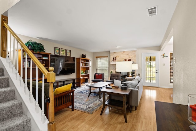 living room featuring a fireplace and light hardwood / wood-style flooring