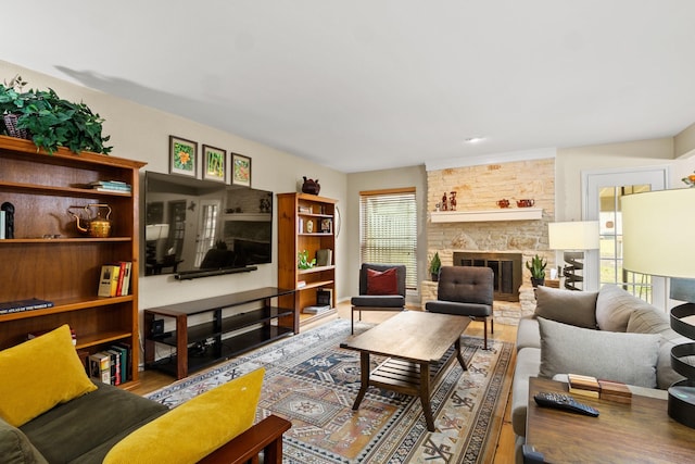 living room featuring plenty of natural light, a fireplace, and wood-type flooring