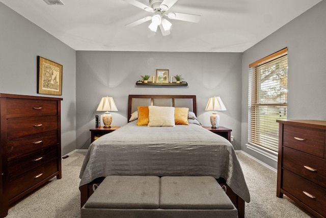 bedroom with ceiling fan and light carpet