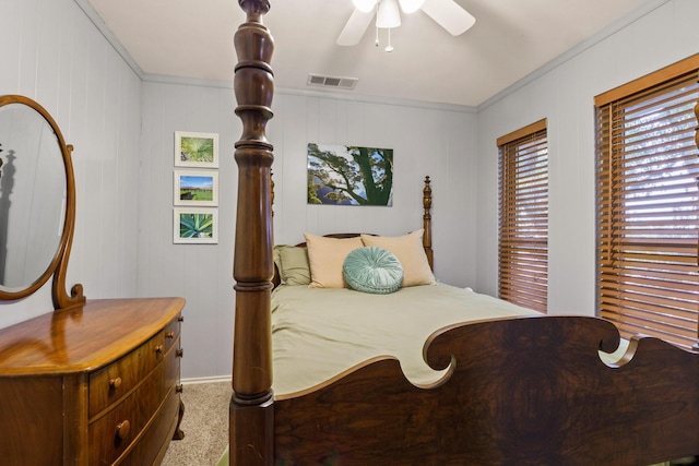 bedroom featuring carpet floors, ornamental molding, and ceiling fan