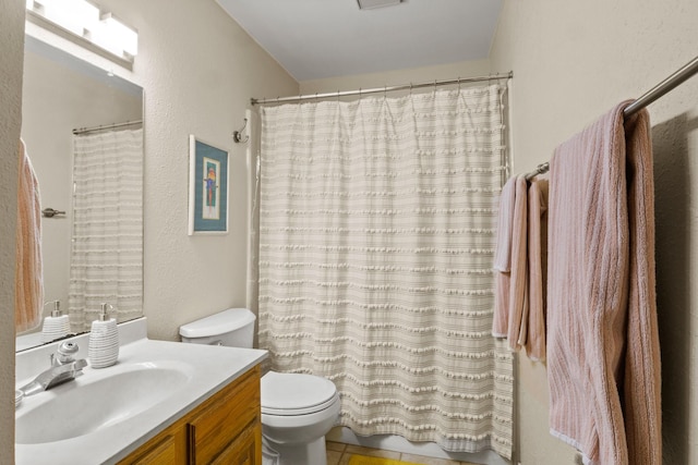 bathroom featuring vanity, curtained shower, and toilet