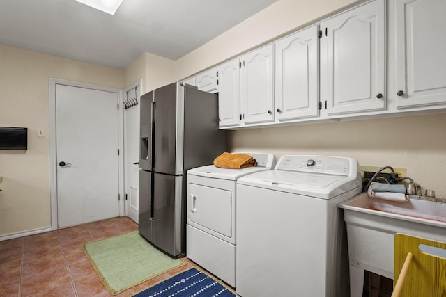 laundry room featuring sink, light tile patterned floors, and independent washer and dryer