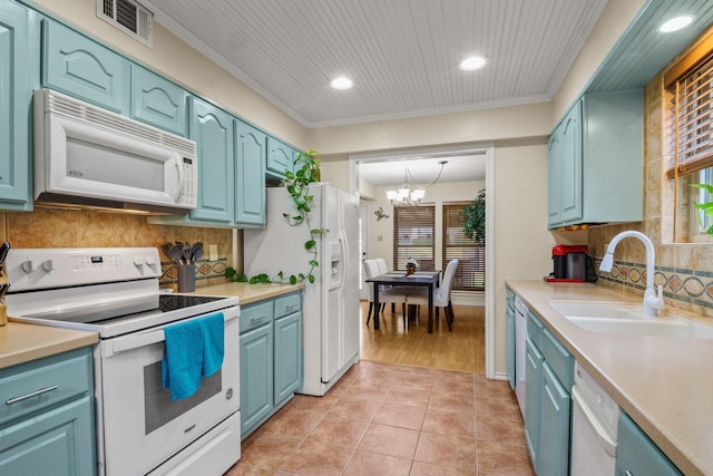 kitchen featuring sink, white appliances, ornamental molding, and decorative backsplash