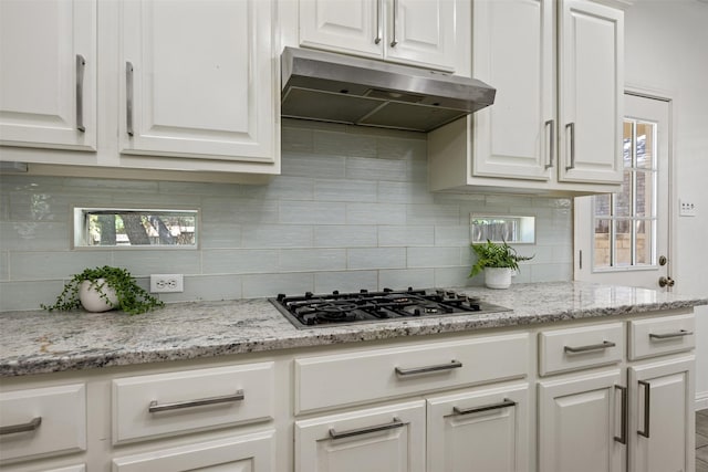 kitchen featuring decorative backsplash, white cabinetry, and stainless steel gas stovetop