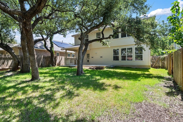 back of property featuring a yard