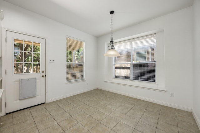 unfurnished dining area with plenty of natural light and light tile patterned flooring