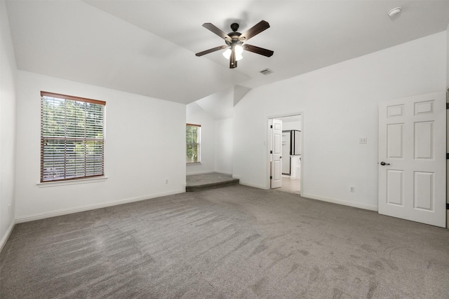 interior space featuring ceiling fan, carpet flooring, and vaulted ceiling