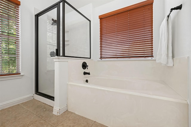 bathroom with independent shower and bath and tile patterned flooring