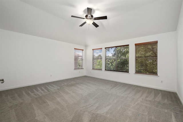 spare room with carpet floors, lofted ceiling, and ceiling fan