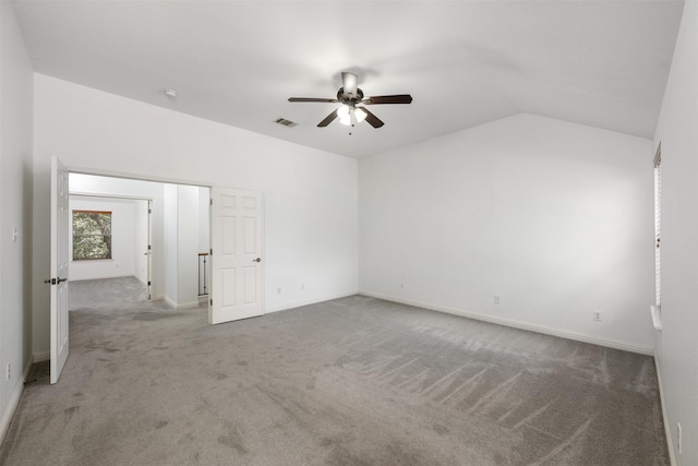 unfurnished room with vaulted ceiling, ceiling fan, and light carpet