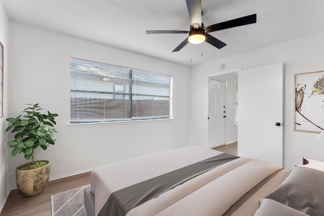 bedroom with ceiling fan and light hardwood / wood-style floors