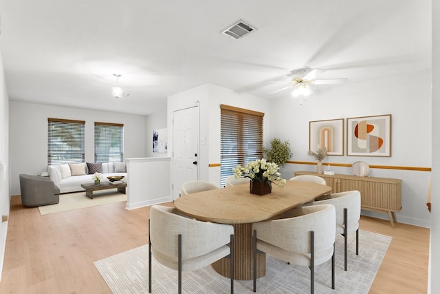 dining room with ceiling fan and light hardwood / wood-style flooring