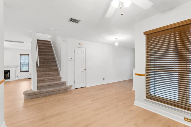 spare room with ceiling fan and light wood-type flooring