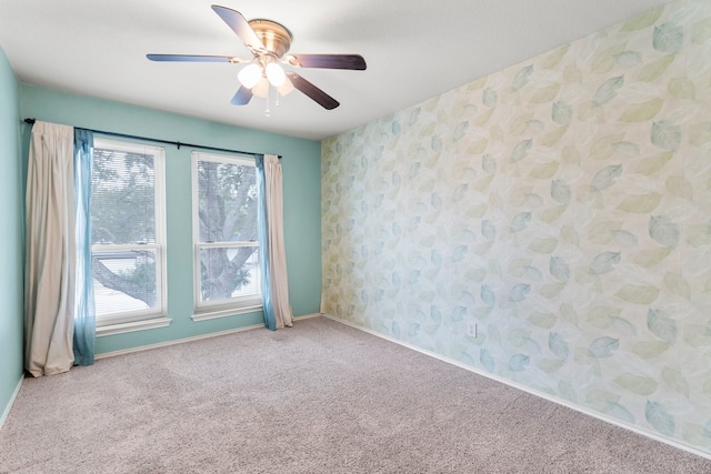 empty room with ceiling fan and light carpet