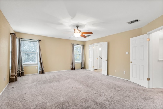 carpeted spare room featuring ceiling fan