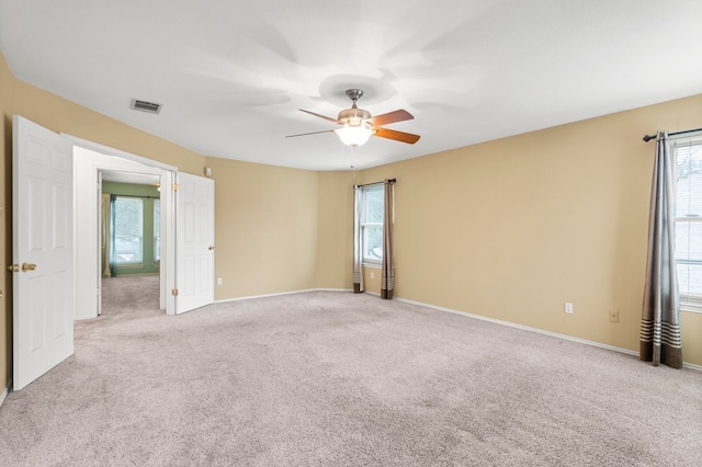 empty room featuring light carpet and ceiling fan