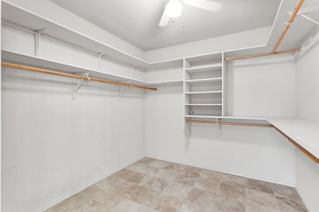 walk in closet featuring ceiling fan