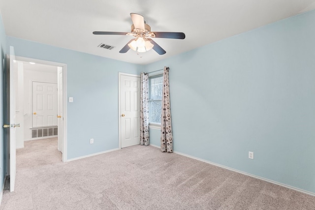 unfurnished room with ceiling fan and light carpet