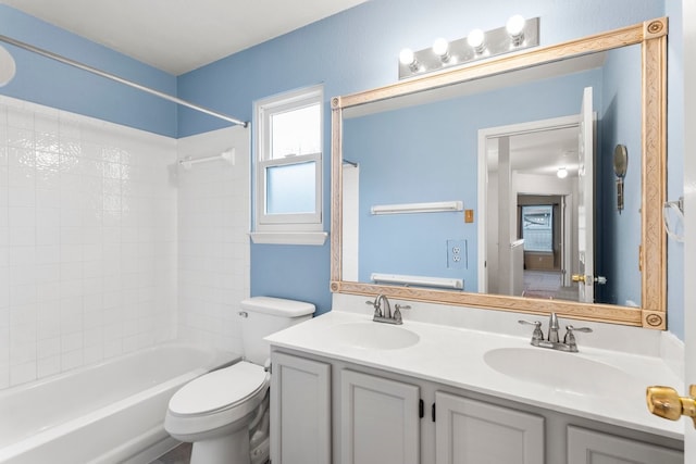 full bathroom with toilet, vanity, and tiled shower / bath