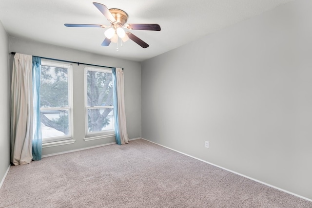 unfurnished room featuring ceiling fan and light colored carpet