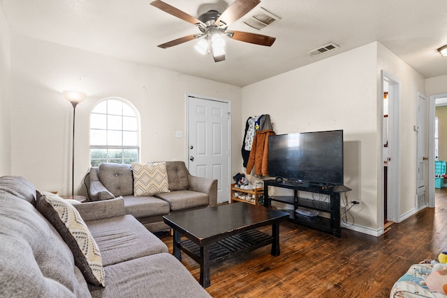 living room with dark wood-type flooring and ceiling fan