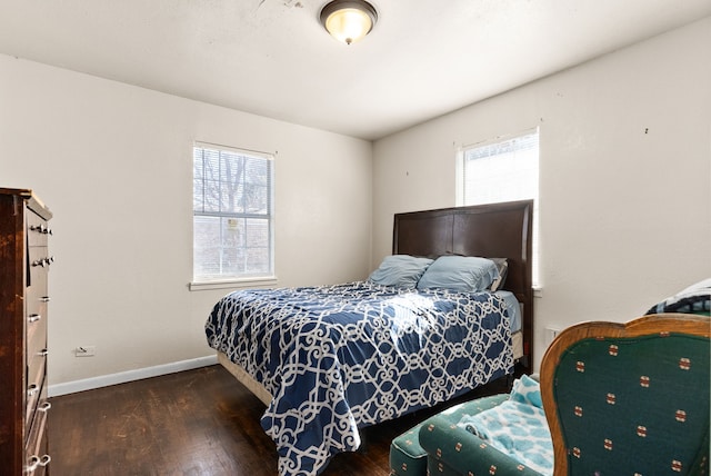 bedroom with dark hardwood / wood-style flooring