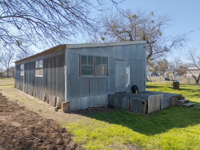 view of outdoor structure featuring a lawn