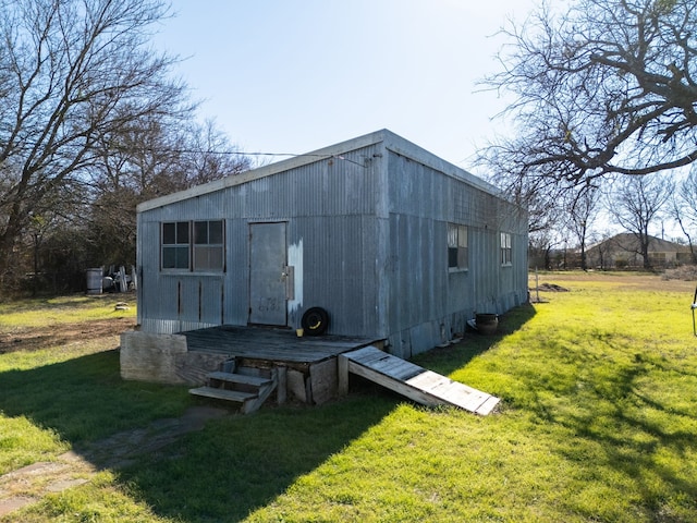 view of outbuilding with a yard