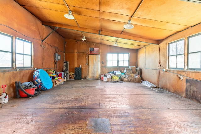 garage featuring wood ceiling and wood walls