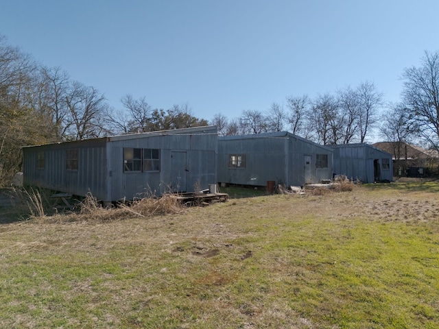 back of house with a lawn