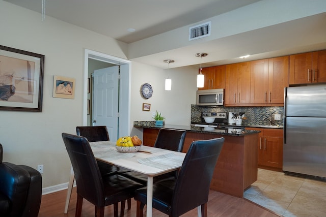 dining room featuring light hardwood / wood-style floors and sink