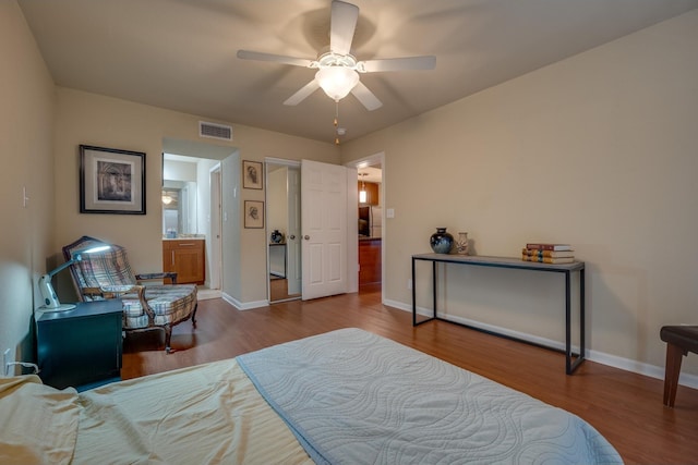 bedroom featuring hardwood / wood-style flooring, connected bathroom, and ceiling fan