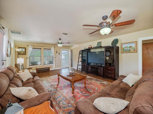 living room with wood-type flooring and ceiling fan