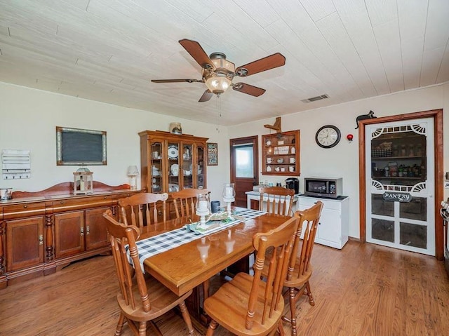 dining room with ceiling fan, hardwood / wood-style floors, and wooden ceiling