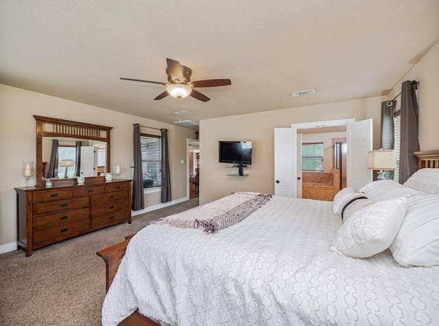 carpeted bedroom featuring a textured ceiling and ceiling fan