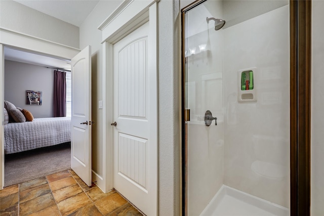 bathroom featuring a shower with shower door