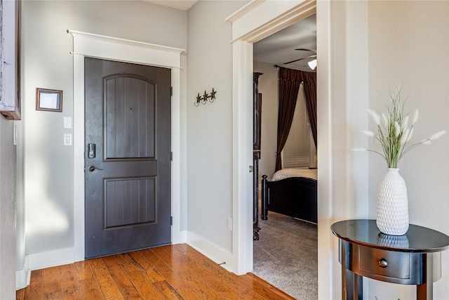 foyer with wood-type flooring and ceiling fan